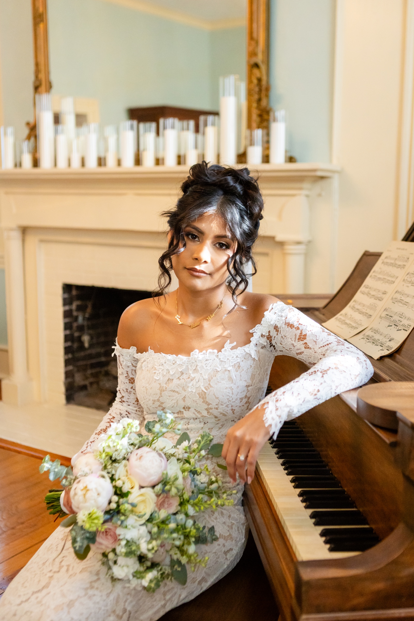 Bride at piano with candles on mantle