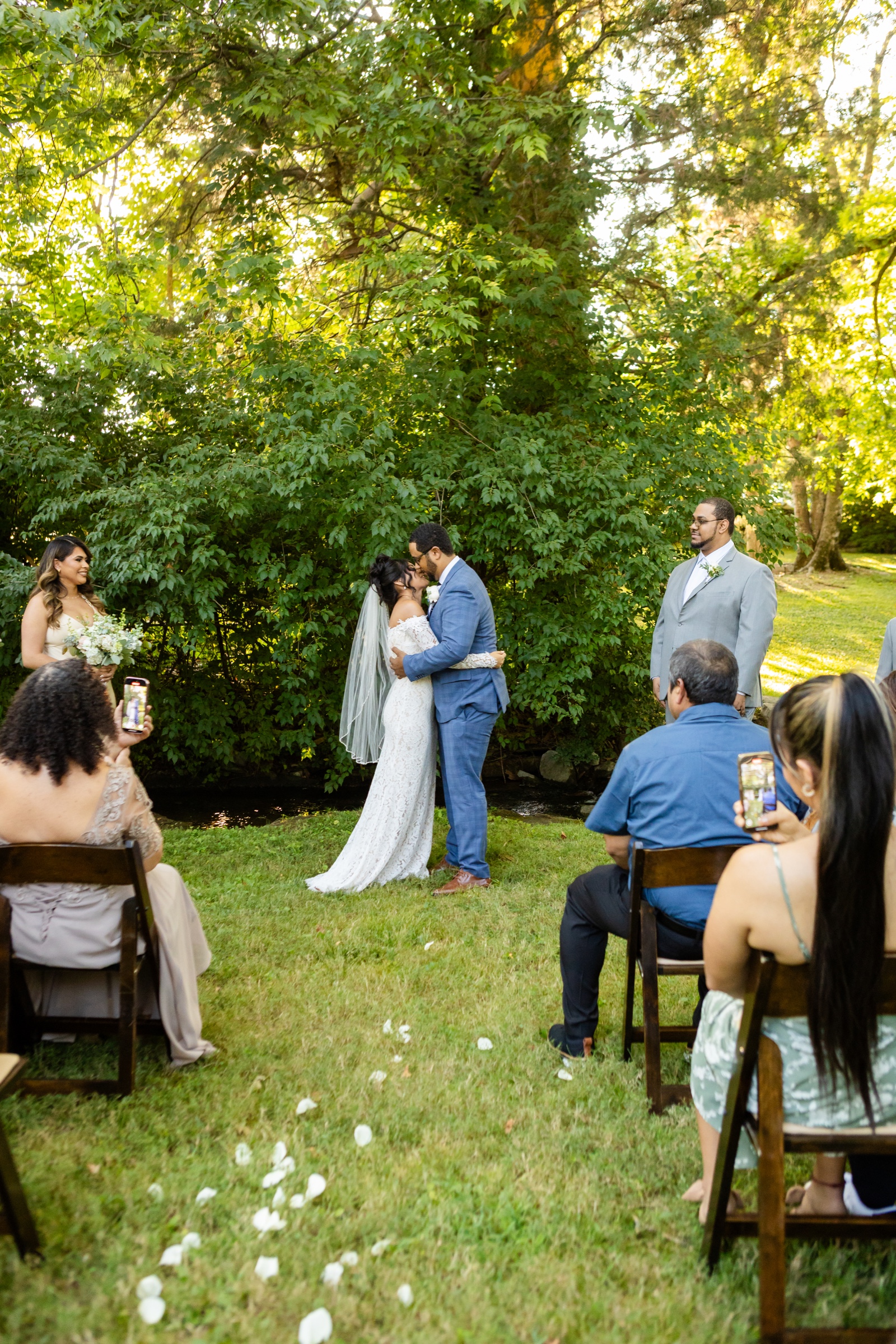 Couple first kiss at outdoor ceremony