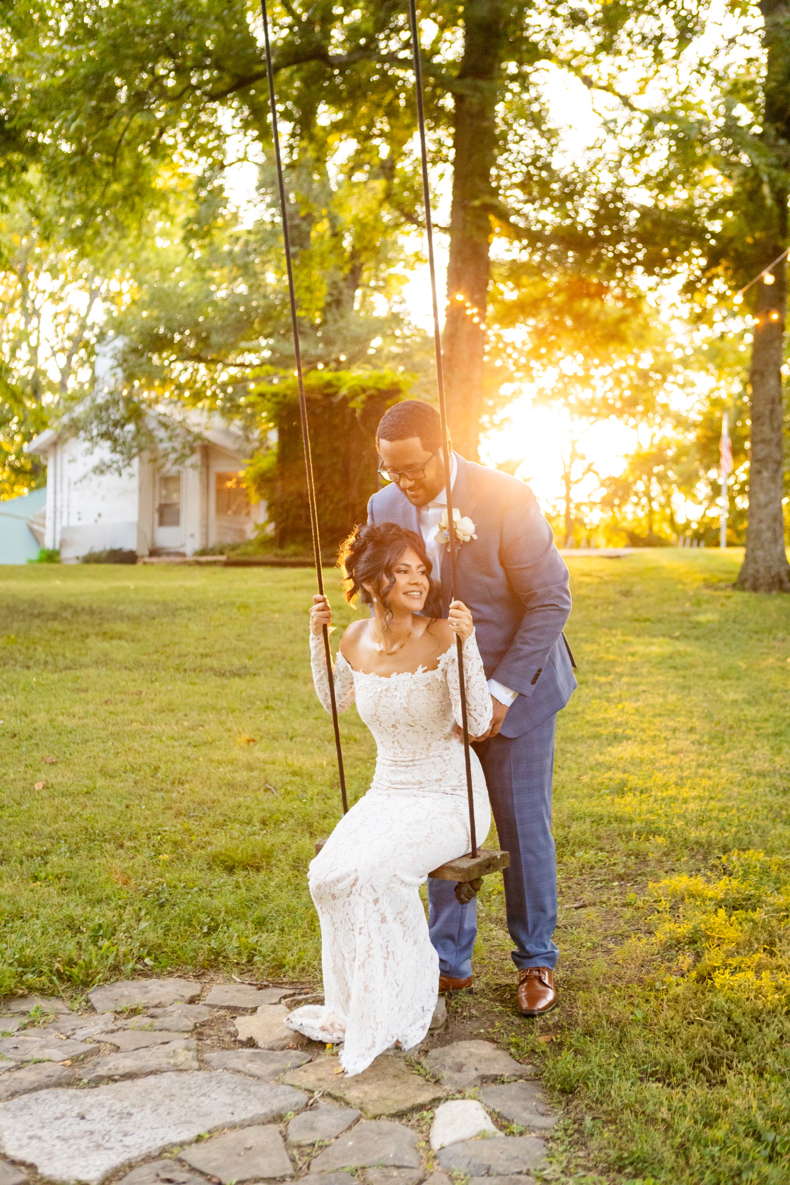 Couple on tree swing at sunset golden hour