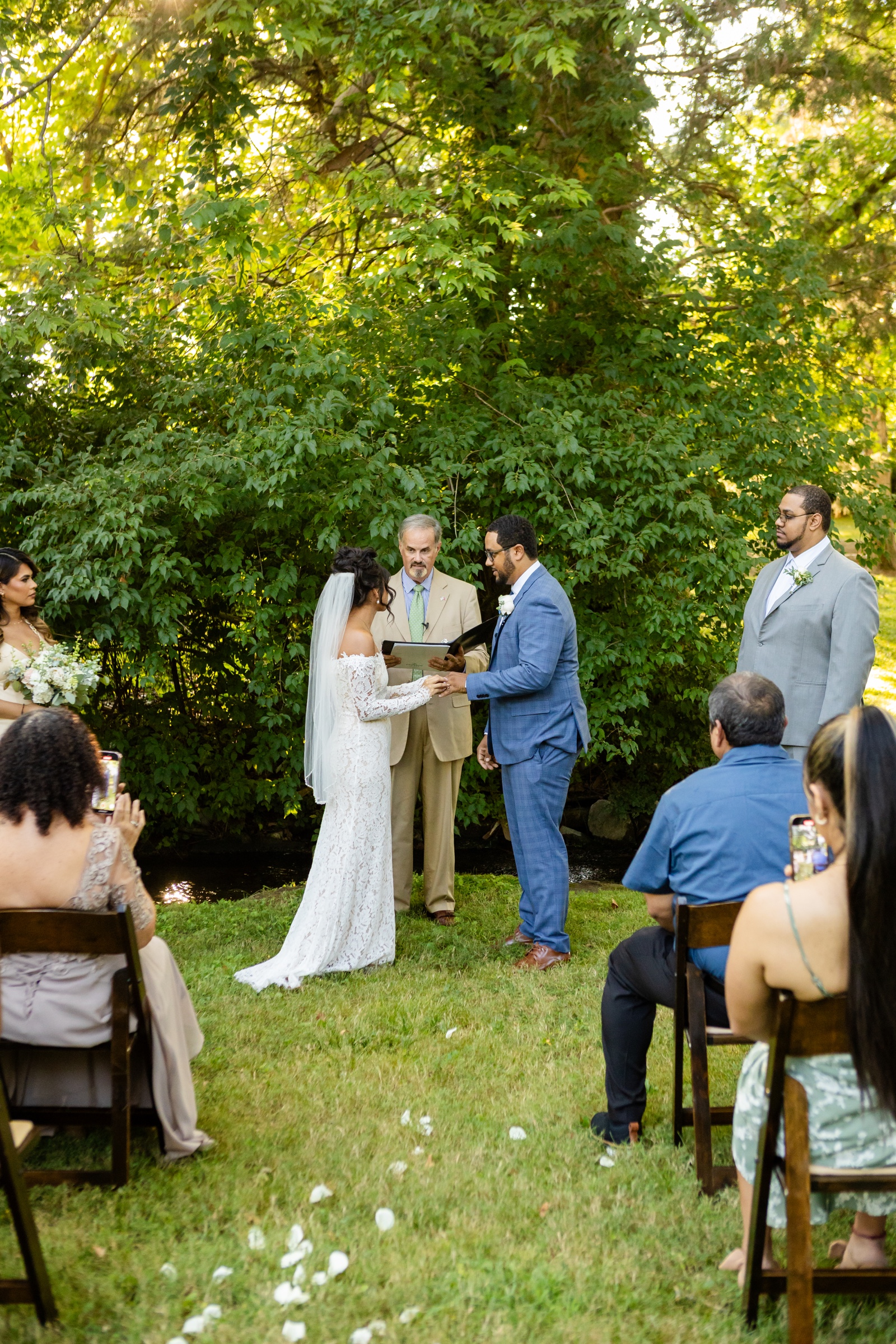 Outdoor wedding ceremony with officiant and guests